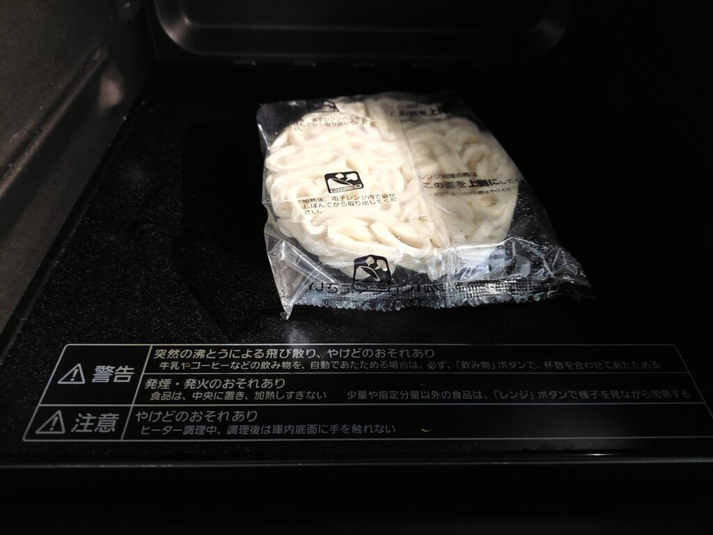 コープ「汁なし肉うどん」電子レンジの中に